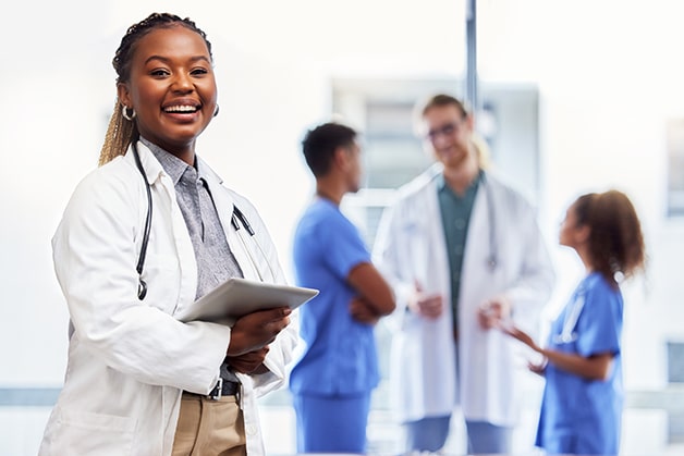 Friendly female doctor holding clipboard